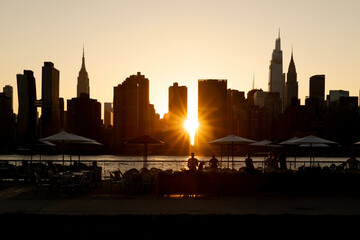 People along the city waterfront watching the sunset