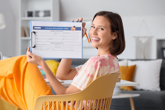 Teenage girl with college application form sitting at home