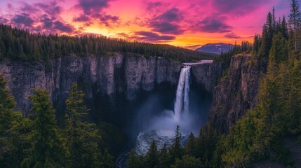 Fototapeta premium Majestic Waterfall Cascading into Canyon at Colorful Sunset