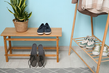 Shoes with orthopedic insoles near bench in hallway interior