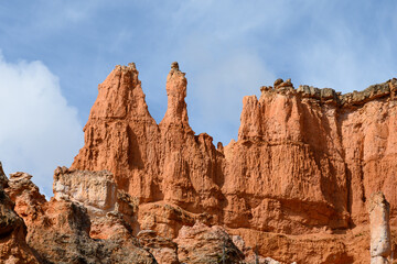 Looking up from base of the amphitheater on queens trail at dramatic orange rock hoodoos, summer vacation exploring in Bryce Canyon National Park, Utah
