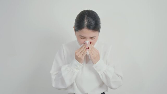 business woman blowing her nose with tissue for concepts of Common Cold, Influenza, Flu, Hay, Fever, Covid 19, Respiratory Infection, Sinusitis, Allergic Rhinitis, Allergy, Medical and health care