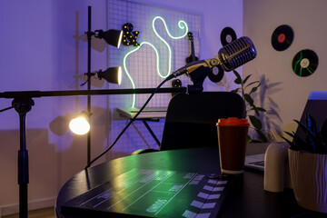Podcaster's workplace with microphone in dark studio
