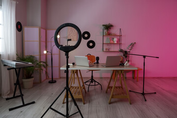 Interior of podcaster's studio with workplace, vinyl disks and folding screen