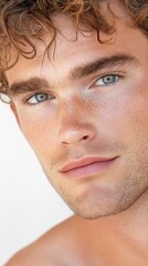 Obraz premium Raw close-up portrait of a man with textured natural hair, light stubble, minor skin imperfections, soft lighting emphasizing authentic skin and hair texture, unfiltered masculinity.