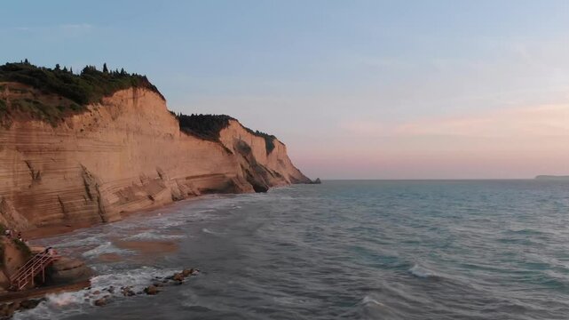 Experience the breathtaking beauty of a sunset over Logas Beach in Peroulades, Corfu, Greece.