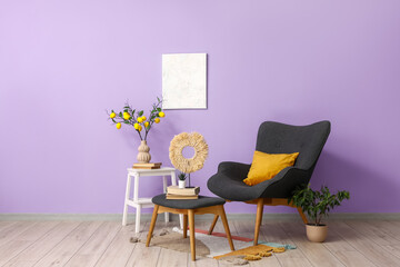 Armchair, stepladder and houseplants near violet wall in interior of living room