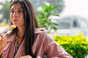Freelancer enjoying breakfast at coffee shop while working remotely