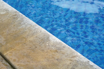 Background of the edge of the swimming pool with blue water