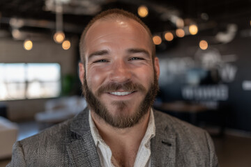 Smiling confident businessman with blurred office background — generative AI