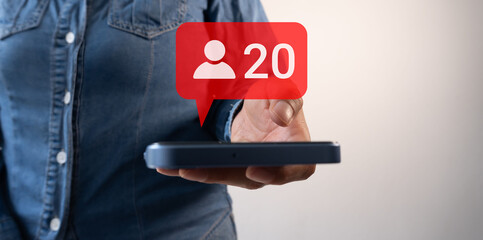 A woman's hand holding a smartphone and a speech bubble icon with a person and the number 20....