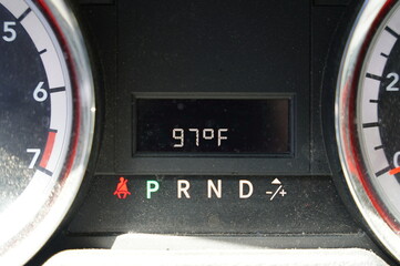 The vehicle temperature monitoring system reads 97 degrees Fahrenheit during hot summer days.