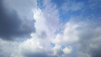 dramatic view Gray storm clouds float across a blue sky