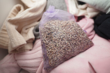 Lavender sachet among folded clothing in a closet