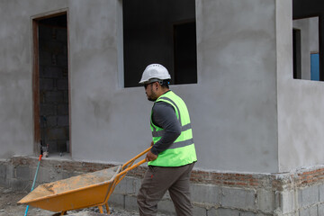 Asian overweight foreman working on construction site wearing safety white helmet working helping...