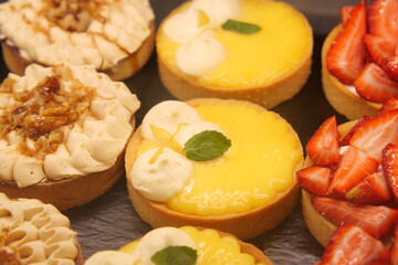 Delicious dessert tarts displayed on rustic table