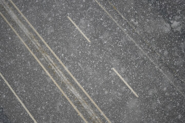 Heavy snowfall covers roads in winter evening