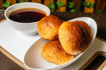 horizontal photo of traditional handmade whole wheat mogolla bread next to a cup of coffee in a...