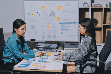Group of young application developers analyzing uxui mobile app templates during a working meeting