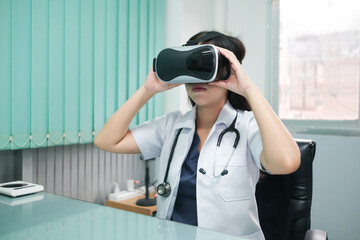 Asian female doctor in the office using VR simulation for training and treating patients.