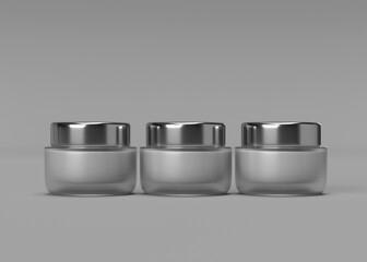 Three Elegant Cosmetic Jars with Silver Lids on Grey Background