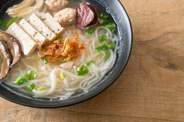 Vietnamese Rice Noodles Soup with Vietnamese Sausage served vegetables and crispy onion