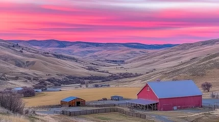 Selbstklebende Fototapeten Scenic rural landscape at sunrise with a vibrant pink sky over a valley and a red barn. © mandul