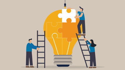 Teamwork and collaboration building a bright idea represented by a puzzle light bulb
