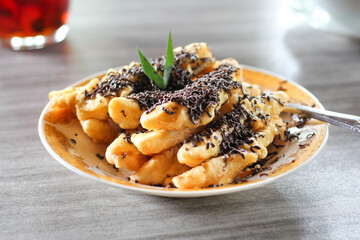 Pisang goreng or fried banana on a plate. with chocolate topping.