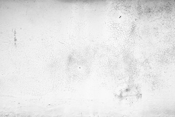 White concrete wall exhibiting rough textured surface with cracks. Cracked concrete surface background texture. 