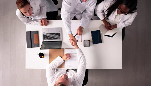 Medical Interview Panel Selecting New Healthcare Team Members Shake