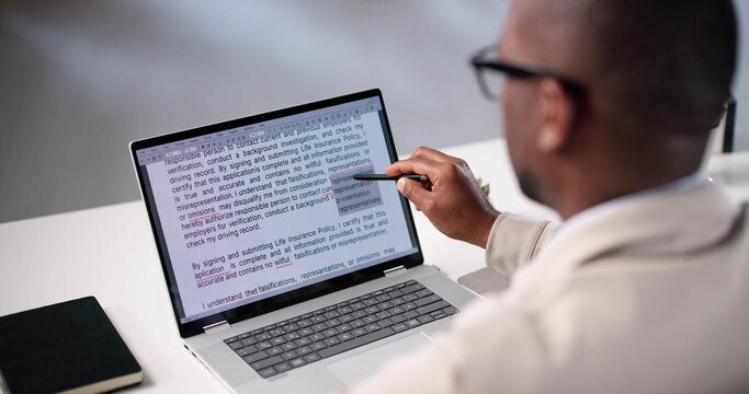 Document Proofreading: African American Man Editing Script Online Spelling