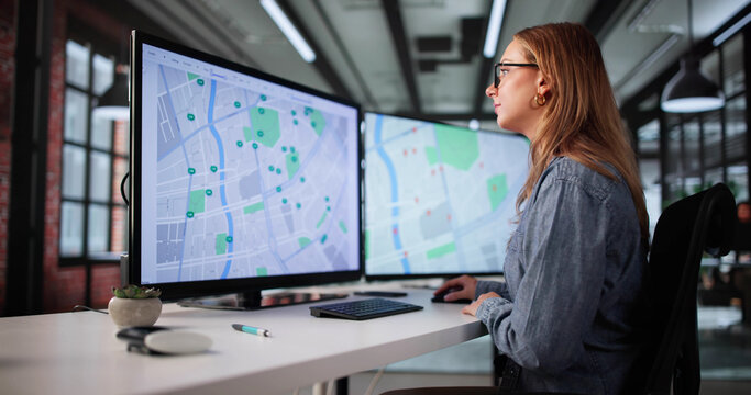 Woman Using Computer To Search For Real Estate Listings Online