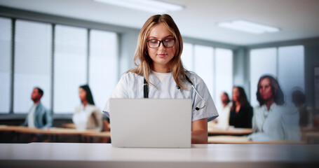 Female Nurse Concentrating On Virtual Medical Lecture