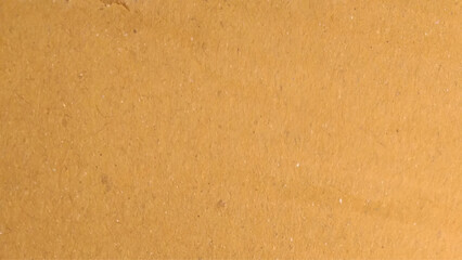 Background of brown kraft paper or cardboard texture. Abstract pattern of beige rough carton, old paper sheet.