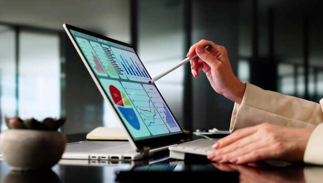 Female Businesswoman Analyzing Financial Data On Laptop