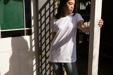 Fototapeta premium Flat illustration showing woman standing in doorway casting lattice shadows over door and vine