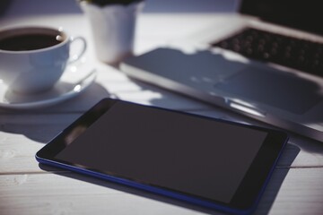Tablet and laptop on table