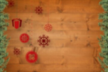 Blurred fir tree branches on wood