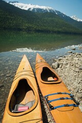 Kayaks at lakeshore on sunny day © vectorfusionart