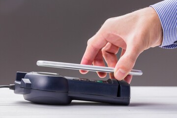 Man using smartphone to express pay