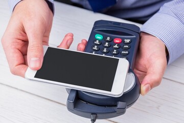 Man using smartphone to express pay