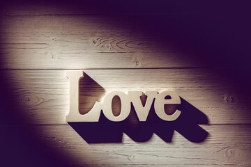 Love text on wooden table