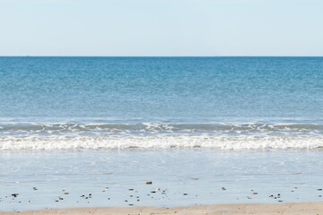 A picture of a beach with a sea background