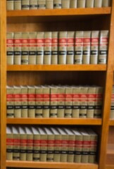 Volumes of books on shelf in library