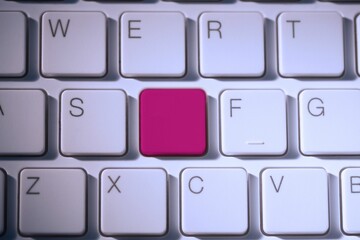 Digital composite of Pink key on keyboard