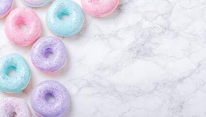 Pastel-colored donuts arranged on a marble surface