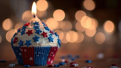 Patriotic cupcake with lit candle on wooden table