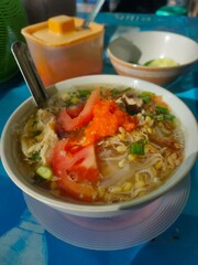 Savory Soup with Tomato, Sprout and Chili Relish in White Bowl