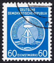 Coat of arms of the German Democratic Republic on a 1954 GDR vintage postage stamp. Hammer and Compass Series
